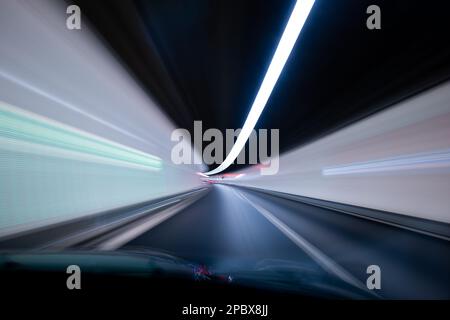 Car driving through a tunnel, blurred light, long exposure, abstract view. Stock Photo