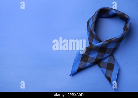 Folded bandana with check pattern on blue background, top view. Space for text Stock Photo