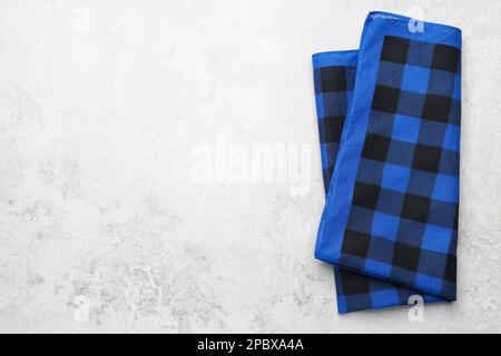 Folded blue checkered bandana on white table, top view. Space for text Stock Photo