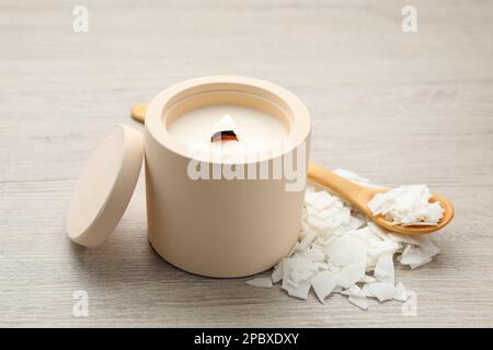 Wooden spoon on heap of soy wax flakes, top view. Homemade candle material  Stock Photo
