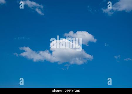 Puffy white clouds set against deep blue sky, no people. Stock Photo