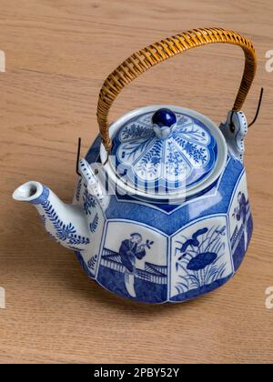 Vintage traditional ceramic Chinese teapot on wooden background Stock Photo