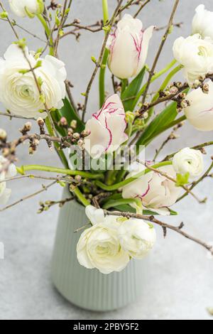 Beautiful spring bouquet with seasonal flowers in interior Stock Photo