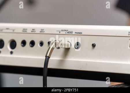 Audio jacks are plugged into a guitar synthesizer or processor Stock Photo