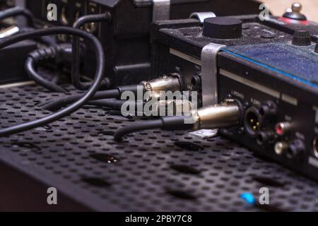 Audio jacks are plugged into a guitar synthesizer or processor Stock Photo