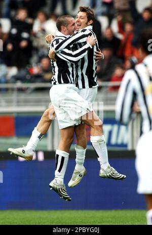 Juventus striker Alessandro Del Piero, center, followed by teammate Giorgio  Chiellini, left, with other teammates, warms-up next to an Italian Serie B  second division sign, at bottom, before the start of the