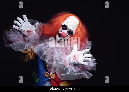 Terrifying Clown On Black Background. Halloween Party Costume Stock 