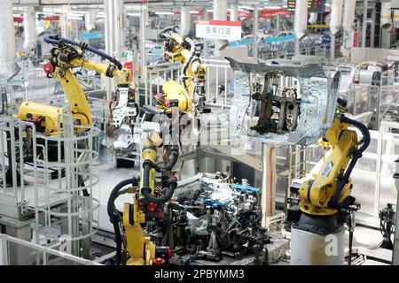 CHONGQING, CHINA - MARCH 13, 2023 - Robots weld a car door in a welding workshop at Great Wall Motor in Chongqing, China, March 13, 2023. Stock Photo