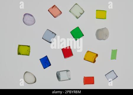 heap of several different transparent colored plastic polymer resins Stock Photo