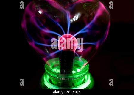 Toy plasma ball glowing in the dark. Stock Photo