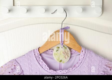 Scented sachet with flowers and stylish clothes on hanger Stock Photo -  Alamy