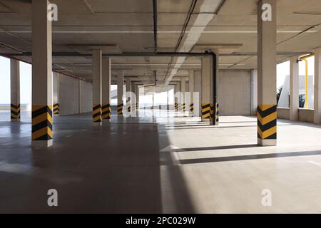 Empty open car parking garage on sunny day Stock Photo