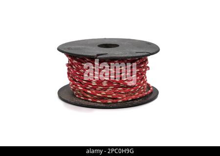 Red and white used builders line on spool, isolated on white background Stock Photo