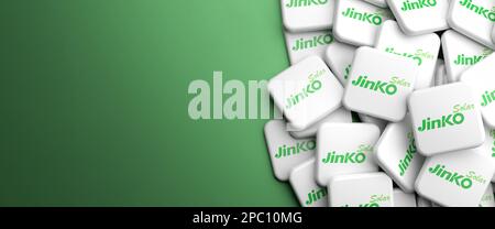 Logos of the chinese solar panel manufacturer JinkoSolar on a heap on a table. Copy space. Web banner format. Stock Photo