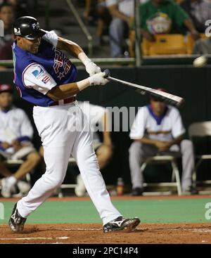 Puerto Rico's Juan Igor Gonzalez swings for a single off the pitch of  Mexico's Elmer Dessens in the second inning of their game in the Caribbean  Baseball Series in Carolina, Puerto Rico