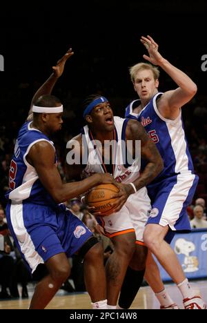 Philadelphia 76ers' Steven Hunter, right, blocks the shot of Los Angeles  Clippers' Cuttino Mobley (5) as teammate Elton Brand, left, looks on during  the first half of a NBA basketball game in