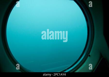 looking out of the porthole window aboard the submarine safaris submarine out of puerto calero Lanzarote, Canary Islands, Spain Stock Photo