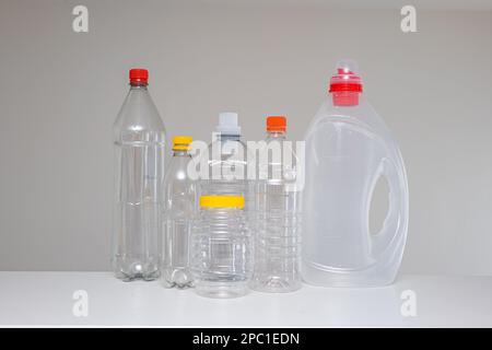 Variety of empty transparent plastic bottles without a label, ready to be recycled. Close up studio shot, no people Stock Photo