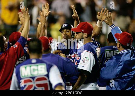 Puerto Rico's Juan Igor Gonzalez swings for a single off the pitch of  Mexico's Elmer Dessens in the second inning of their game in the Caribbean  Baseball Series in Carolina, Puerto Rico