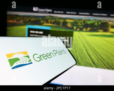 Smartphone with logo of American ethanol company Green Plains Inc. on screen in front of business website. Focus on center of phone display. Stock Photo