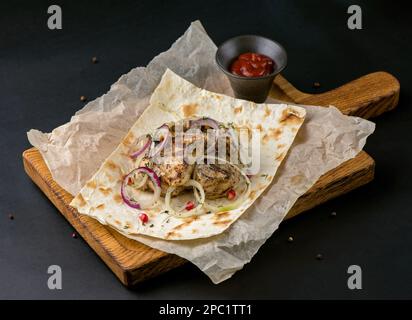 spicy grilled spare ribs on plate over dark stone background with copy space. Top view, flat lay Stock Photo