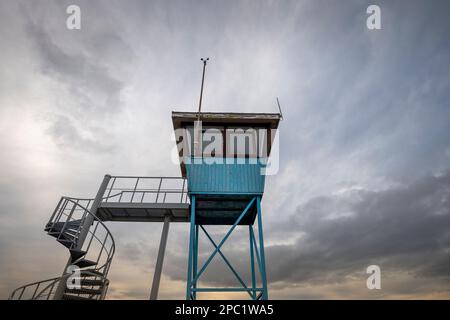 Blue watch tower against a dramatic sky Stock Photo