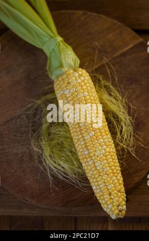 Fresh corn on cobs on rustic wooden table. Sweet corn ears background Stock Photo