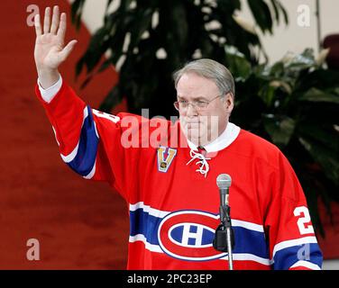 Former Montreal Canadiens goaltender Ken Dryden is applauded by Canadiens  Cristobal Huet, Saku Koivu and Christopher Higgins, left to right, as he is  introduced at the Bell Centre as his jersey is