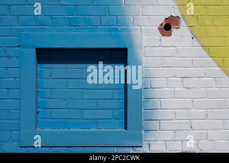 Vividly painted brick wall with wooden frame in Charlotte, NC Stock Photo