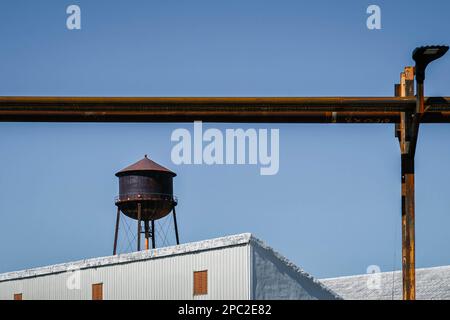 Corrosion on water tower and pipes with white rooves Stock Photo