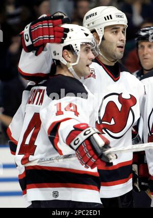 FILE ** Buffalo Sabres' Chris Drury battles for the puck with New Jersey  Devils' Scott Gomez (23) during the second period of the NHL hockey game at  HSBC Arena in Buffalo