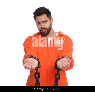 Prisoner in jumpsuit with chained hands on white background Stock Photo