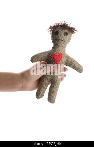Woman holding voodoo doll with pins on white background, closeup Stock Photo