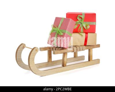 Wooden sleigh with Christmas gift boxes on white background Stock Photo