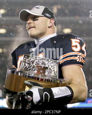 Chicago Bears' Brian Urlacher holds the NFC Championship Trophy as