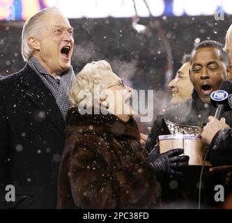 Chicago Bears chairman Michael McCaskey, left, and owner Virginia McCaskey  , center, react as they are presented with the George Halas Trophy after  the Bears beat the New Orleans Saints, 39-14, to