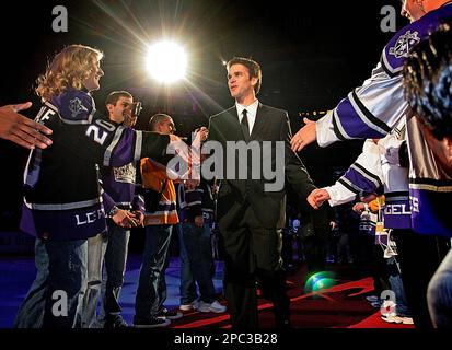 Former Los Angeles Kings' Luc Robitaille is greeted by fans as he walks  onto the ice at Staples Center during a ceremony retiring his jersey  number, 20, Saturday, Jan. 20, 2007, in