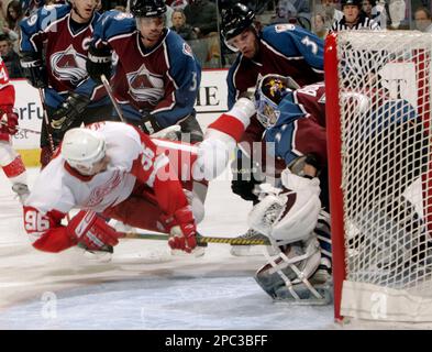 https://l450v.alamy.com/450v/2pc3bff/detroit-red-wings-left-winger-tomas-holmstrom-front-left-of-sweden-is-tripped-by-colorado-avalanche-defenseman-karlis-skrastins-third-from-left-in-back-of-latvia-as-avalanche-center-joe-sakic-far-left-and-defenseman-brett-clark-second-from-left-in-back-and-goalie-peter-budaj-front-right-of-slovakia-look-on-in-the-second-period-of-an-nhl-hockey-game-in-denver-on-saturday-jan-20-2007-ap-photodavid-zalubowski-2pc3bff.jpg