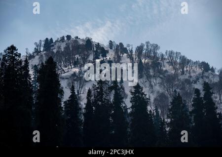 A Mountain Is Seen Partially Covered With Snow During A Sunny Day At ...