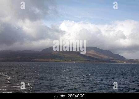 Cloud passing over Goat Fell as viewed from the ferry Caledonian Isles travelling between Brodick and Ardrossan the Isle of Arran Scotland Stock Photo