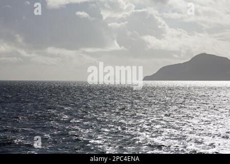 Holy Island with Ailsa Craig in the distance from the ferry Caledonian Isles travelling between Brodick on the Isle of Arran and Ardrossan Scotland Stock Photo