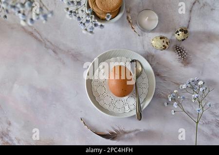 Easter composition of eggs and flowers on a light background. Easter bunny. A gentle greeting card for the Easter holiday.Top view, copy location, fla Stock Photo