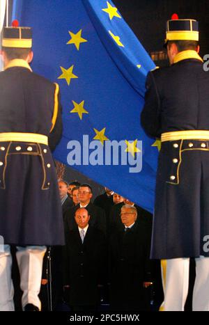 Romanian President Traian Basescu, left, attends together with European Parliament President Josep Borrell, right, and other EU officials a ceremony at the government headquarters for raising the European Union flag in Bucharest Romania Sunday Dec. 31, 2006. On Jan. 1, 2007 Romania and Bulgaria bring 30 million people into the European Union, expanding the bloc's membership to 27 nations. But the two ex-communist Balkan nations   hailing from one of the poorest corners of Europe   are joining under strict conditions and at a time when EU leaders are putting the brakes on further enlargement. (