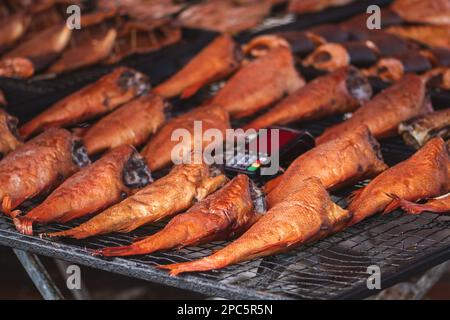 Selling various smoked fish in a street food market in Vilnius, Lithuania, Europe, close up, vertical Stock Photo