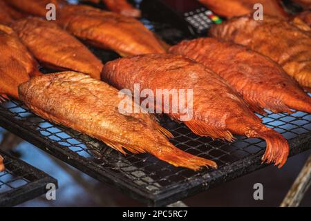 Selling various smoked fish in a street food market in Vilnius, Lithuania, Europe, close up, vertical Stock Photo