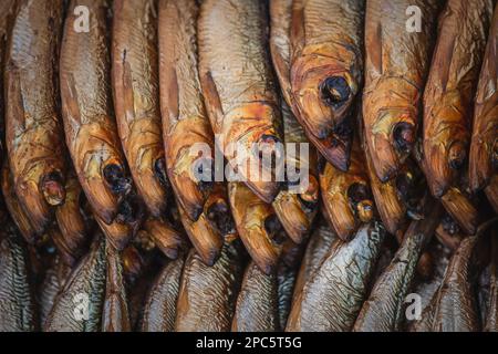 Dried smoked Atlantic or Baltic herrings, Clupea harengus, a herring in the family Clupeidae in a street food market in Vilnius, Lithuania, Europe Stock Photo