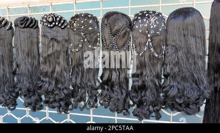 Bangalore,Karnataka,India-January 01 2023: Womens black hair wig is on sale in the streets of Shivaji nagar, Opposite to Busstand, Bangalore. Stock Photo