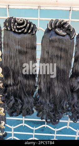 Bangalore,Karnataka,India-January 01 2023: Womens black hair wig is on sale in the streets of Shivaji nagar, Opposite to Busstand, Bangalore. Stock Photo