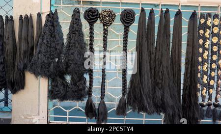 Bangalore,Karnataka,India-January 01 2023: Womens black hair wig is on sale in the streets of Shivaji nagar, Opposite to Busstand, Bangalore. Stock Photo