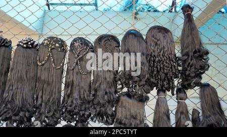 Bangalore,Karnataka,India-January 01 2023: Womens black hair wig is on sale in the streets of Shivaji nagar, Opposite to Busstand, Bangalore. Stock Photo